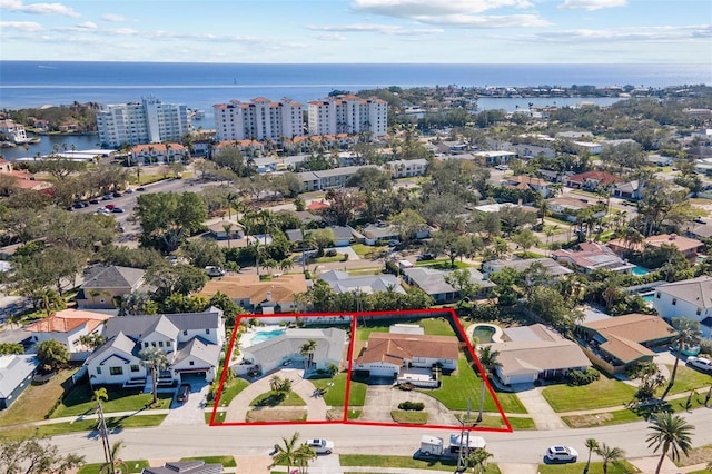 birds eye view of property with a water view