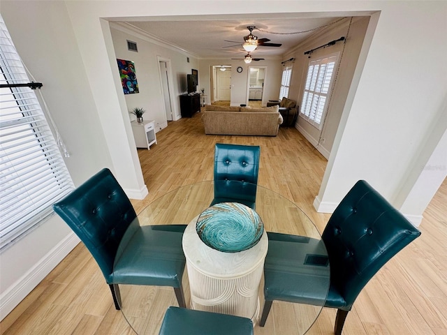 interior space with ceiling fan, ornamental molding, and wood-type flooring