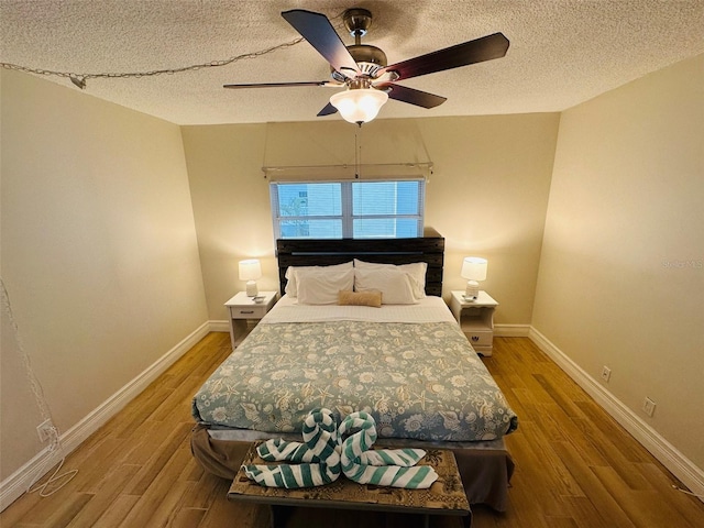 bedroom featuring hardwood / wood-style floors, a textured ceiling, and ceiling fan