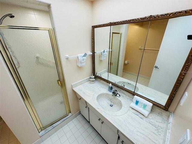 bathroom with tile patterned floors, an enclosed shower, and vanity