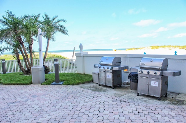 view of patio featuring a water view and grilling area