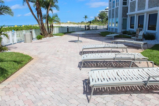 view of property's community with a water view and a patio area