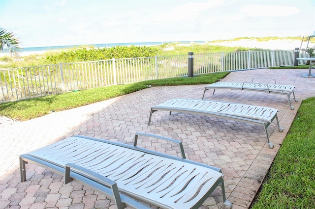 view of patio with a water view