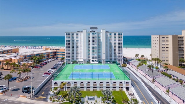 drone / aerial view with a water view and a beach view