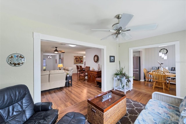 living room featuring wood-type flooring and ceiling fan