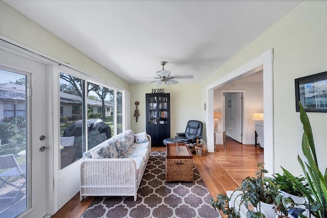 living room featuring dark hardwood / wood-style floors and ceiling fan