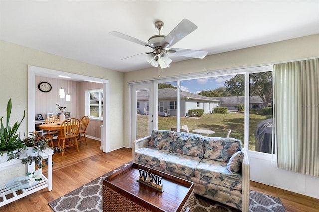 living room with wood-type flooring and ceiling fan