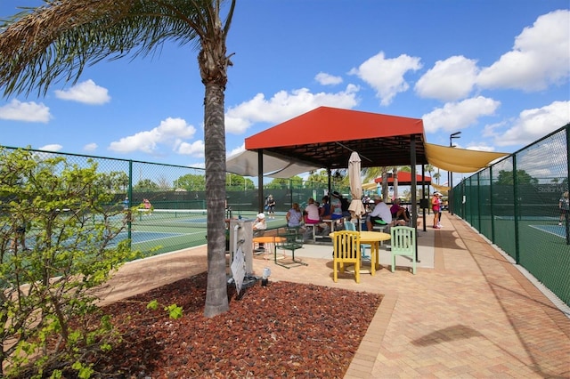 view of community featuring tennis court