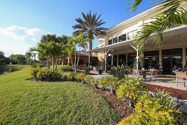 exterior space featuring a water view, a yard, and a patio area