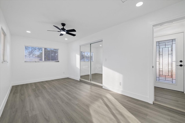 empty room with hardwood / wood-style floors and ceiling fan