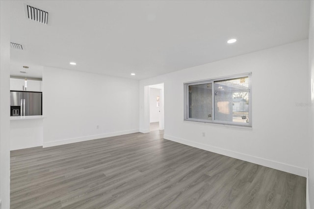 unfurnished living room with hardwood / wood-style flooring