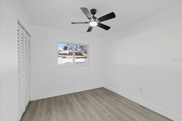 empty room with light hardwood / wood-style floors and ceiling fan