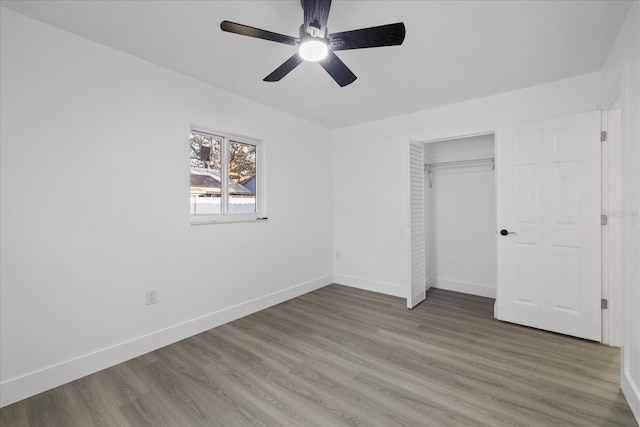 unfurnished bedroom with hardwood / wood-style floors, ceiling fan, and a closet