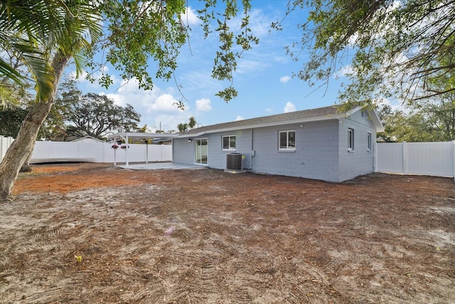 rear view of property featuring a patio and central AC