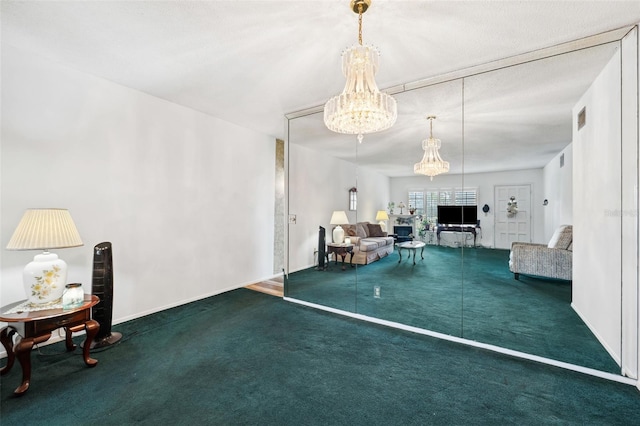 living room featuring a chandelier and carpet