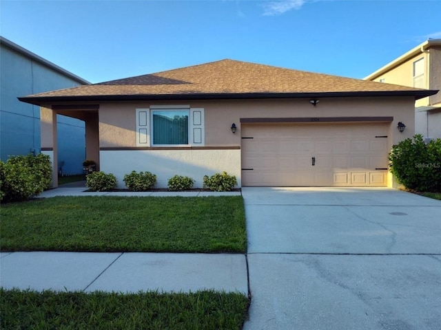 ranch-style home with an attached garage, driveway, a front yard, and stucco siding