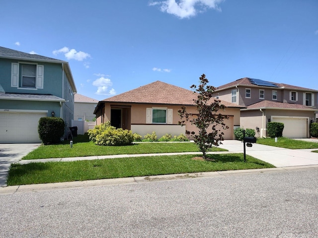 view of front of home with driveway, a front yard, and stucco siding