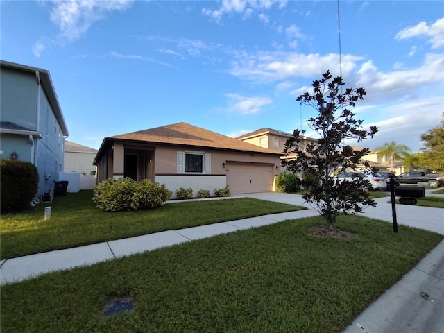 view of front of property with a front lawn, driveway, an attached garage, and stucco siding