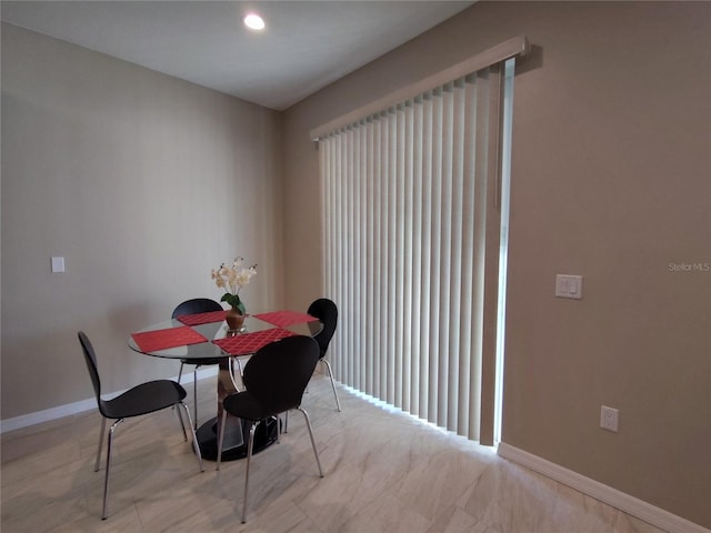 dining space featuring baseboards and recessed lighting