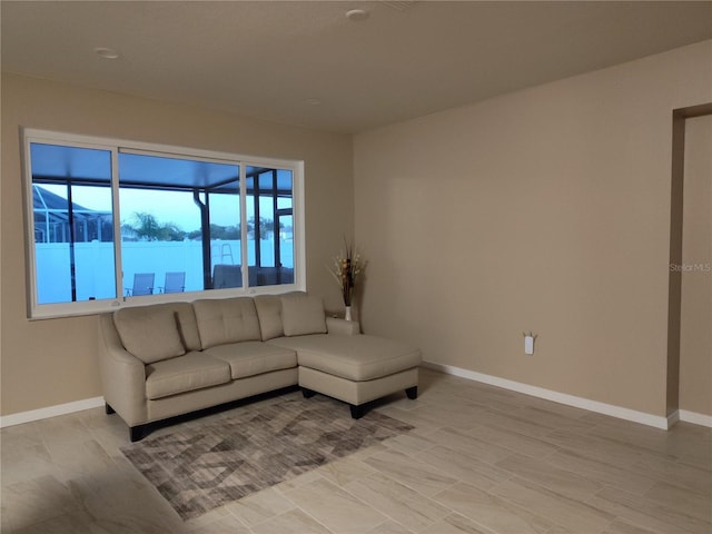 living area featuring baseboards