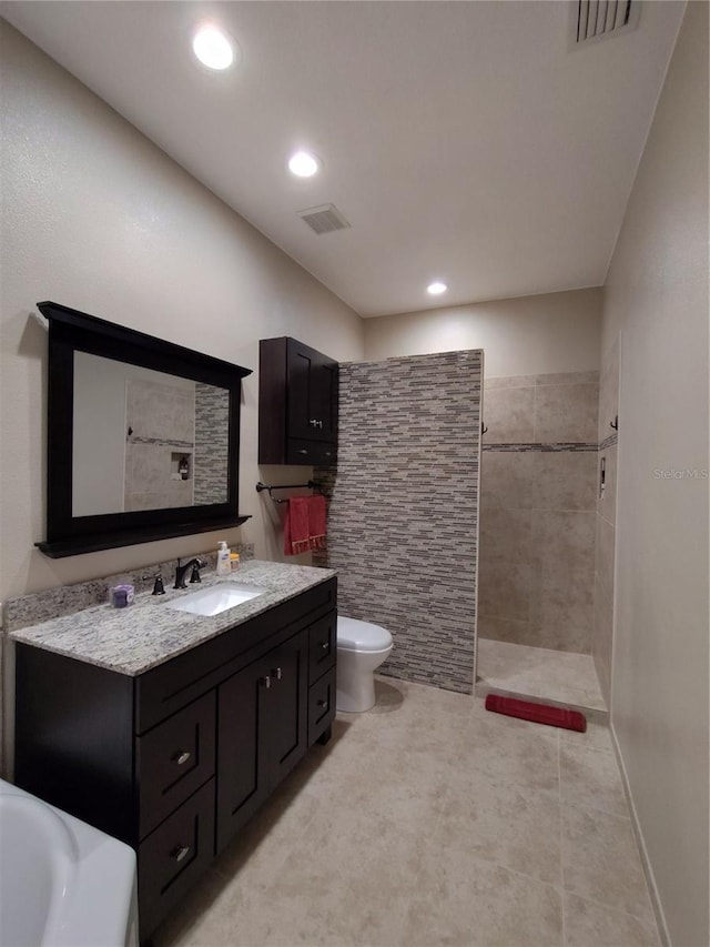 full bath featuring toilet, walk in shower, vanity, and visible vents