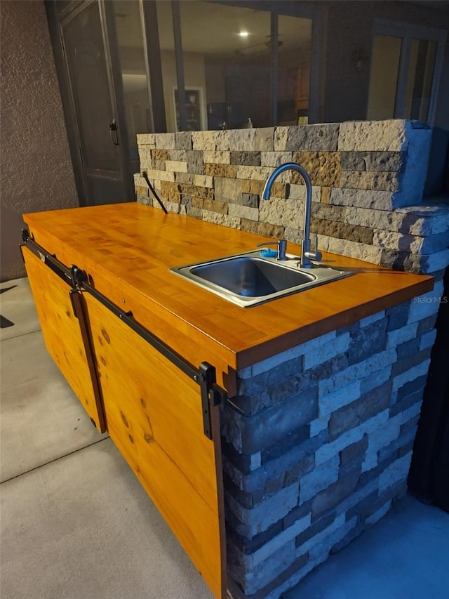 kitchen featuring butcher block counters and a sink