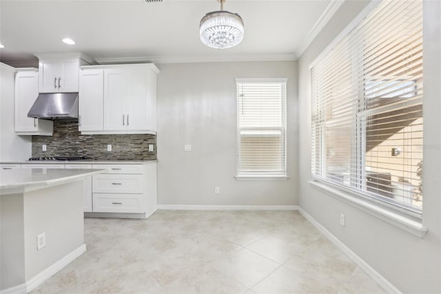 kitchen with crown molding, light stone countertops, decorative backsplash, and white cabinets