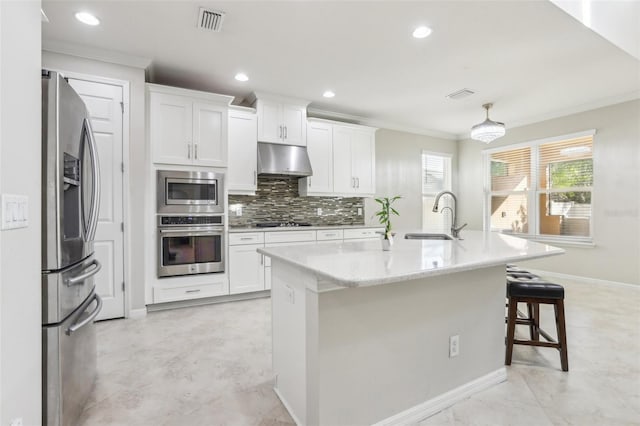 kitchen with white cabinetry, sink, stainless steel appliances, crown molding, and a center island with sink