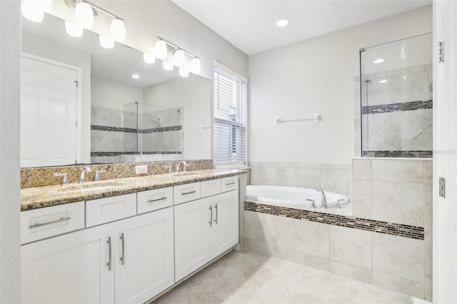 bathroom featuring vanity and independent shower and bath