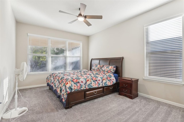 bedroom with ceiling fan and light carpet