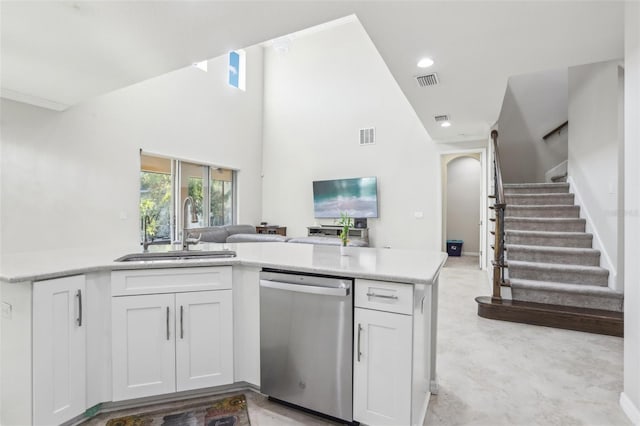 kitchen featuring dishwasher, sink, and white cabinets