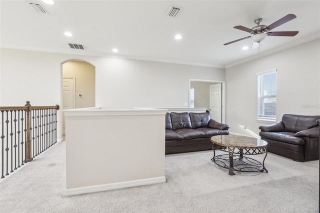 living room featuring crown molding, light carpet, and ceiling fan