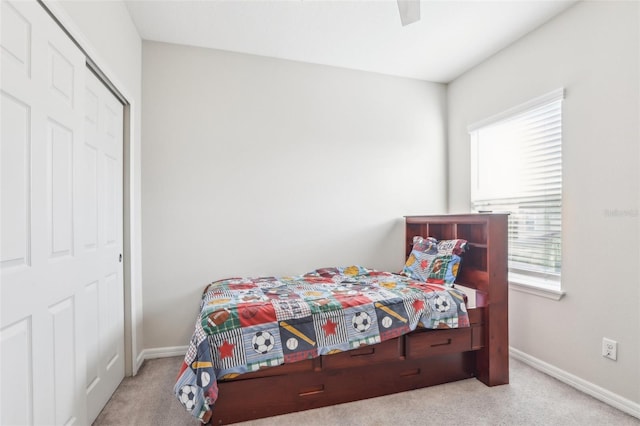 carpeted bedroom featuring multiple windows and ceiling fan