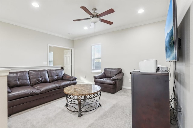 living room featuring ceiling fan, ornamental molding, and light carpet