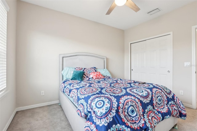 carpeted bedroom with multiple windows, a closet, and ceiling fan