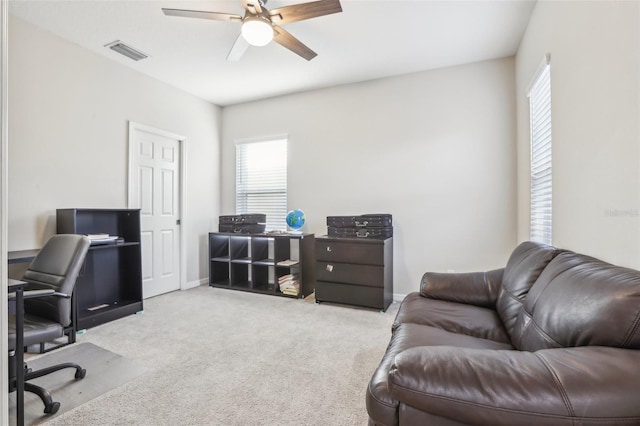 carpeted office with ceiling fan