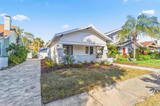 view of front of home featuring a front yard and covered porch