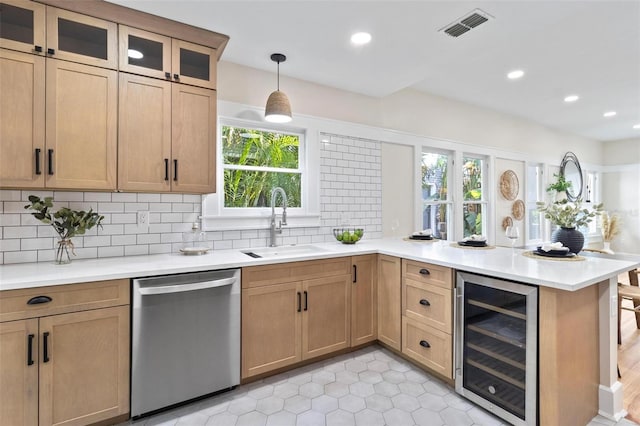 kitchen with decorative light fixtures, tasteful backsplash, sink, beverage cooler, and stainless steel dishwasher