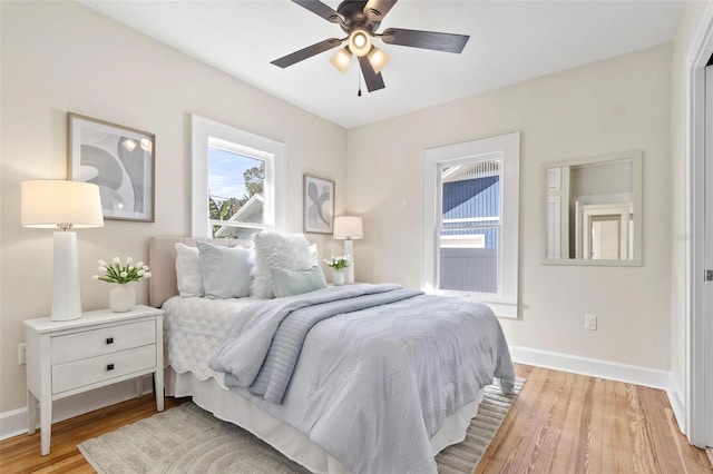 bedroom with light hardwood / wood-style flooring and ceiling fan