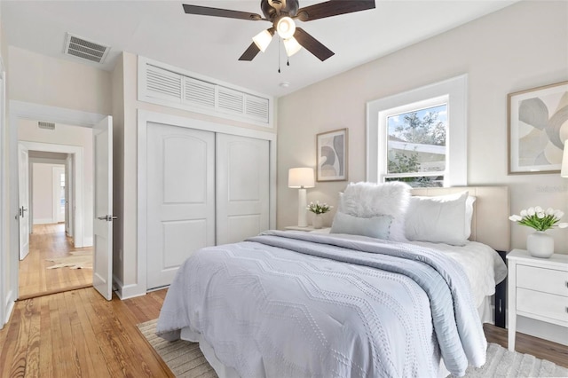 bedroom featuring ceiling fan, a closet, and light hardwood / wood-style flooring