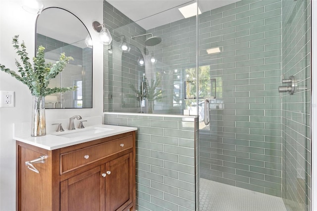 bathroom with vanity and a shower with shower door