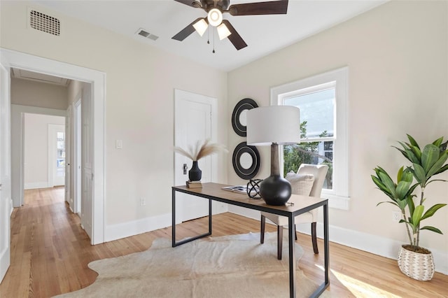 office space with ceiling fan and light hardwood / wood-style floors