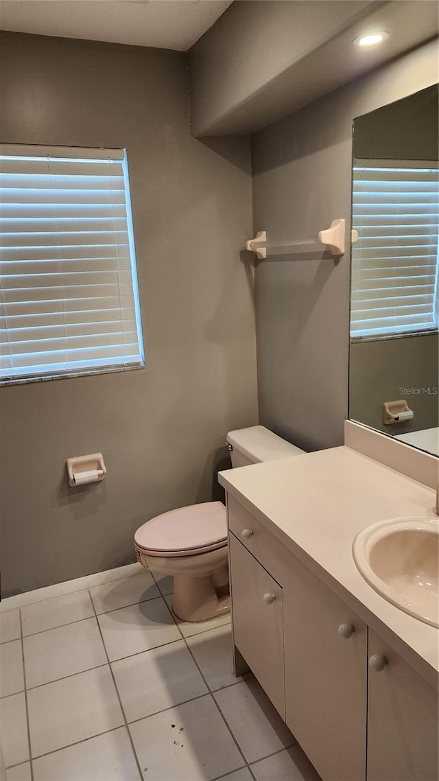 bathroom featuring vanity, tile patterned floors, and toilet