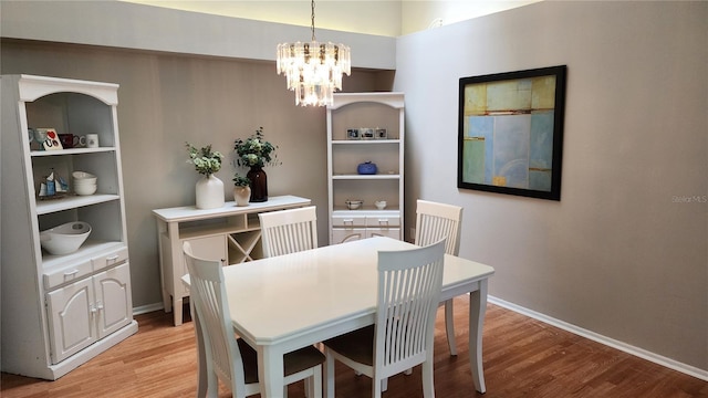 dining area with a chandelier and light hardwood / wood-style floors