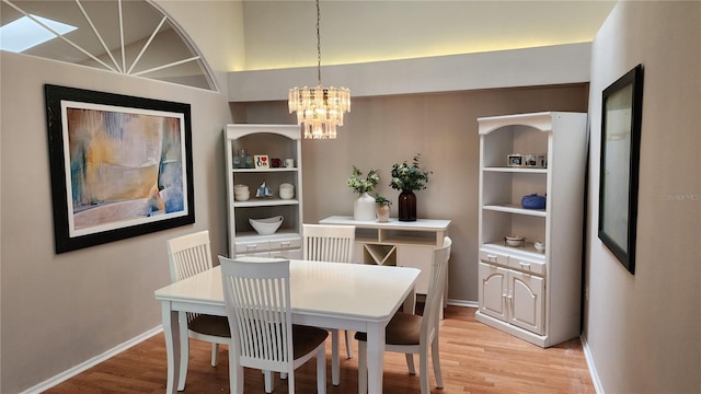 dining space featuring an inviting chandelier and light hardwood / wood-style floors