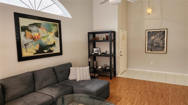 living room with wood-type flooring and ceiling fan