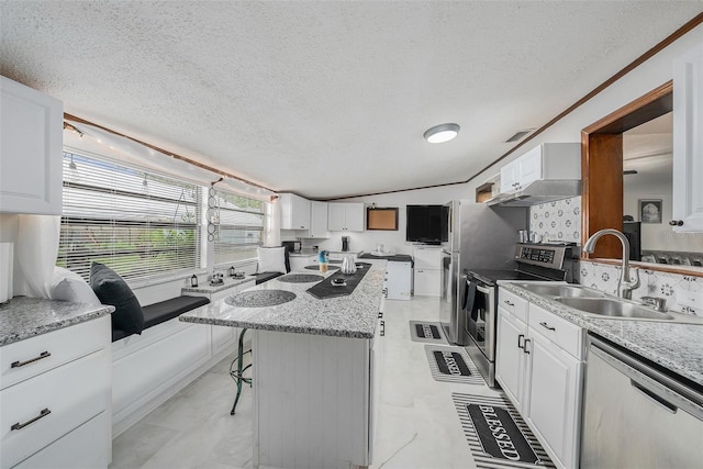 kitchen featuring appliances with stainless steel finishes, a center island, and white cabinets