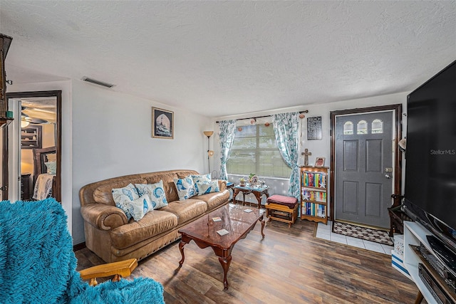 living room with hardwood / wood-style floors and a textured ceiling