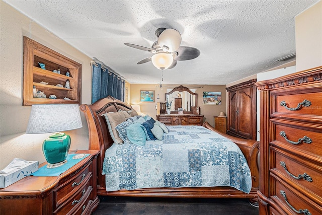 bedroom with ceiling fan and a textured ceiling