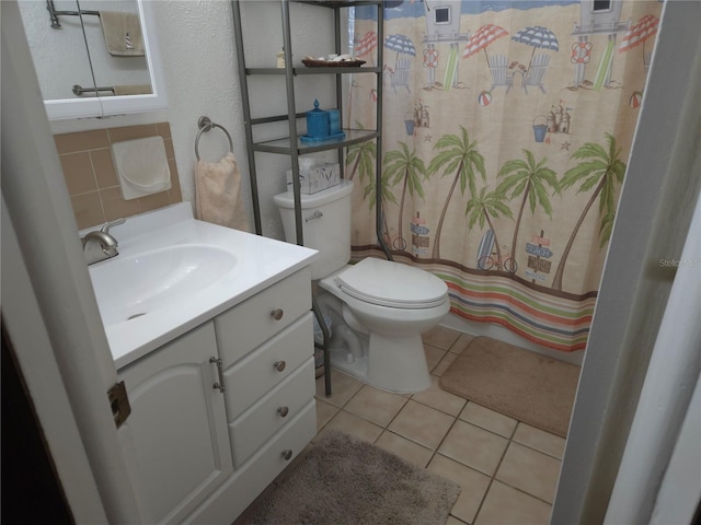 bathroom featuring tile patterned flooring, vanity, decorative backsplash, and toilet